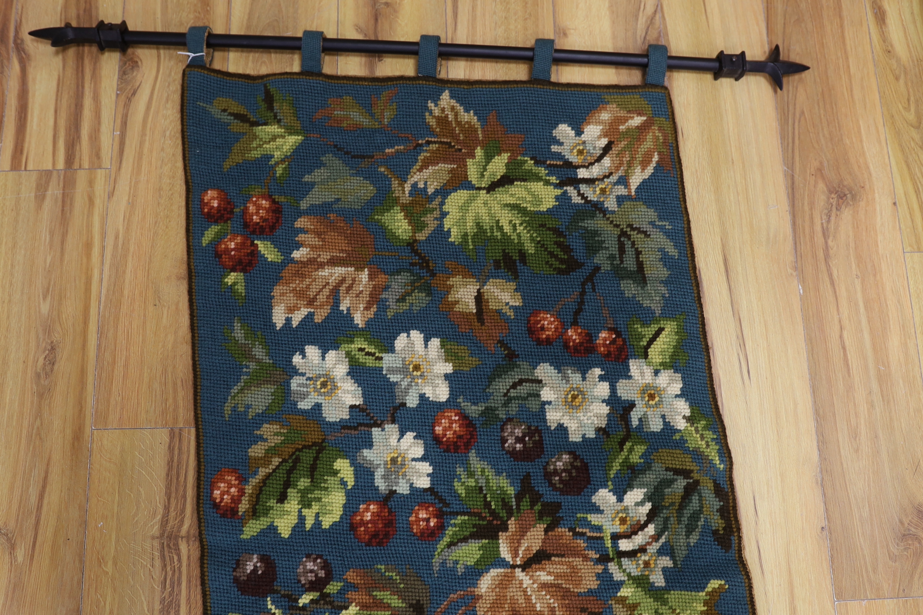 A 20th century woolworked hanging, leaves and flowers, monogrammed and dated
